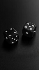 Two black dices on a black surface with white dots