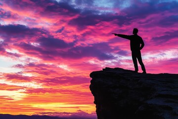 Fototapeta premium A person stands at the edge of a cliff, gazing up at the sky
