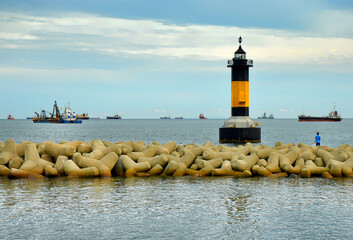 Lighthouse and breakwatersi in Songdo beach, Busan, South Korea.