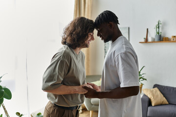Obraz premium Two partners share a tender moment, smiling and connecting deeply in their cozy living space.