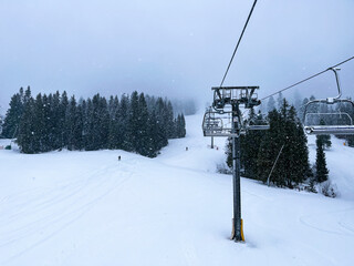 Ski Lift snowy mountain winter forest with chair lift At The Ski Resort in winter. Snowy weather Ski holidays Winter sport and outdoor activities Outdoor tourism