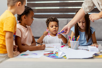 Children engaged in art activities at home together