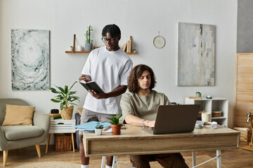 Fototapeta premium Two partners enjoy each other while working on projects in their inviting home office.