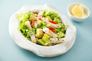 Squid salad with avocado and peanuts