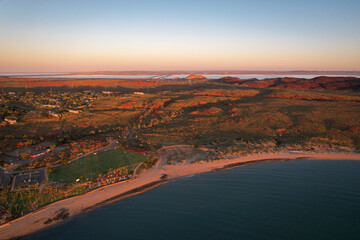 Aerial view of tranquil sunset over the sandy beach and expansive ocean at Dampier foreshore, Hampton Oval, Pilbara Region, Ashburton, Western Australia, Australia.