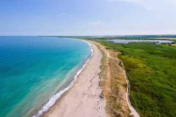 Durankulak, Bulgaria - 12 June 2024: Aerial view of serene Durankulak Beach with tranquil waves and picturesque coastline, Shabla Municipality, Bulgaria.