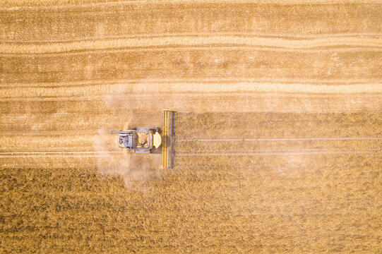 Aerial view of agricultural fields with crops and a tractor in the countryside, Cherna Mogila, Bulgaria.