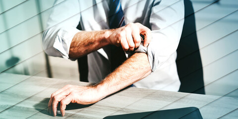 Businessman rolling up his sleeves, geometric pattern