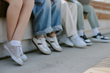 Medium close up of different kinds of shoes on kids feet