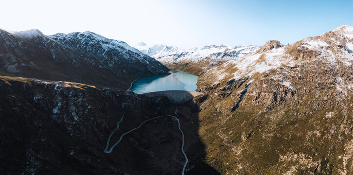 Aerial view of serene Moiry Lake with majestic mountains and a dam, Grimentz, Switzerland.