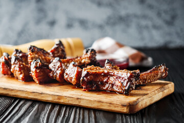 Rustic Grilled BBQ Ribs with Red Sauce Pork and Beef Roasted on Charcoal Wooden Background Delicious Meal