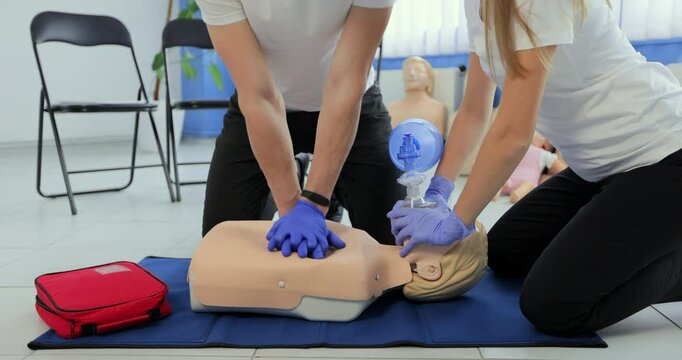 Training compression on a dummy. CPR exercise on a mannequin in the medical center.
