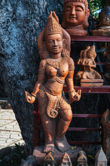 Fototapeta premium Clay Buddhist figurine statue of a female deity in a souvenir shop in Vietnam in Asia