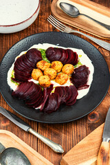 Plate of falafel balls with vegetables.