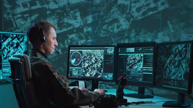 Military soldier operating advanced technology in a command center.
