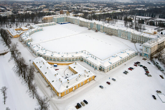 Aerial view of Catherine's Palace surrounded by snow-covered trees and elegant architecture, Pushkin, Russia.