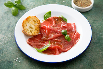 Traditional beef carpaccio with salt and pepper