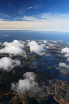 Aerial view of tranquil Onega Bay with beautiful islands and serene clouds under a blue sky, Arkhangelsk oblast, Russia.