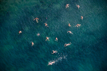 Russia - 23 July 2008: Aerial view of people swimming in the turquoise ocean with waves, Krasnodar Territory, Russia.