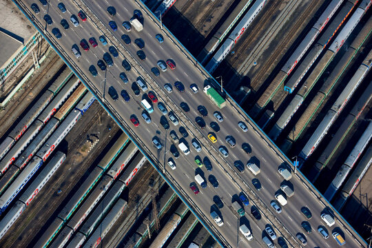 Aerial view of busy urban landscape with cars and trains on roads and bridges, Moscow, Russia.