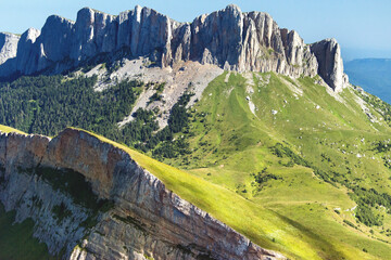Aerial view of majestic Caucasus Mountains with rugged peaks and lush greenery, Novoprokhladnoe, Russia.