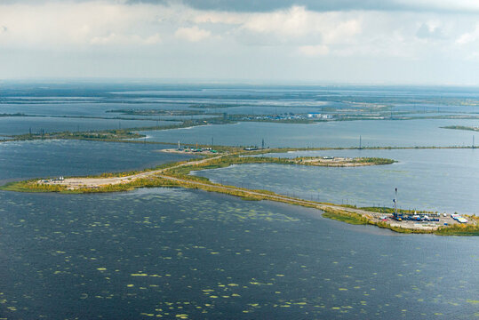 Aerial view of serene Lake Samotlor surrounded by tranquil wetlands and islands, Tyumen Oblast, Russia.