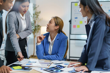 Businesspeople collaborating on a project, analyzing financial charts and graphs, developing growth strategies, and working together in the office