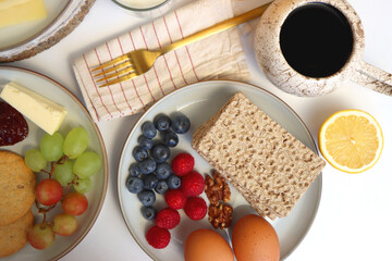 Assortment of various breakfast foods and drinks on the white table. Flat lay.