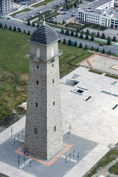 Aerial view of concorde tower and urban cityscape with plaza and roads, Magas, Russia.