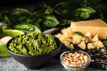 Homemade Pesto Sauce with Pine Nuts and Basil: Ingredients on Black Background
