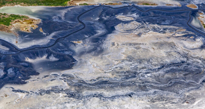 Aerial view of beautiful salt lake with unique patterns in the serene steppe, Volgograd Oblast, Russia.