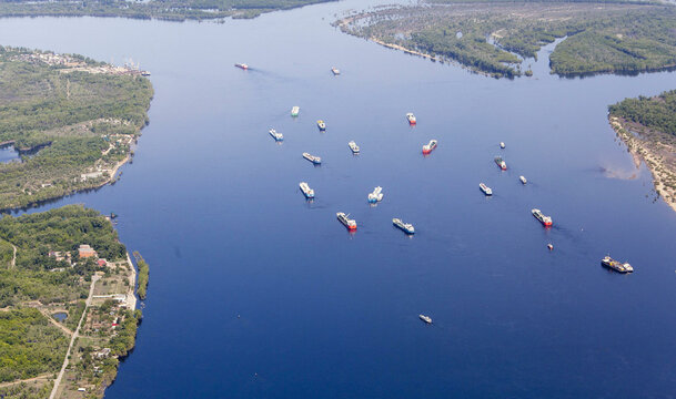 Aerial view of the tranquil Volga River with boats and serene natural beauty, Volgograd Oblast, Russia.