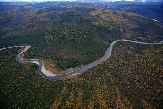Aerial view of autumn siberian taiga with winding ob river and lush forest, Khanty Mansi Autonomous Okrug, Russia.