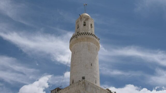 Old Sana'a City Grand mosque white minaret low angle with clouds and sky