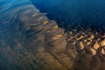 Aerial view of serene and beautiful abstract patterns of water and sand along the coastline, Vishkil, Russia.