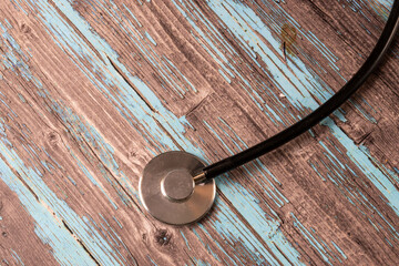 stethoscope and wooden background