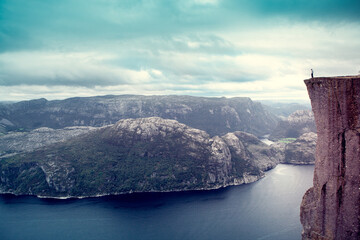  despaired man standing on the famous Preikestolen Pulpit Rock