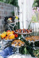Elegant outdoor fruit and pastry table setting.