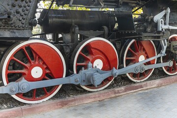 Mechanical wheels of a transport steam locomotive on rails