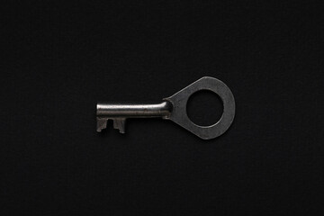 Vintage Metal Key on Minimalist Black Background for Security and Design Concepts