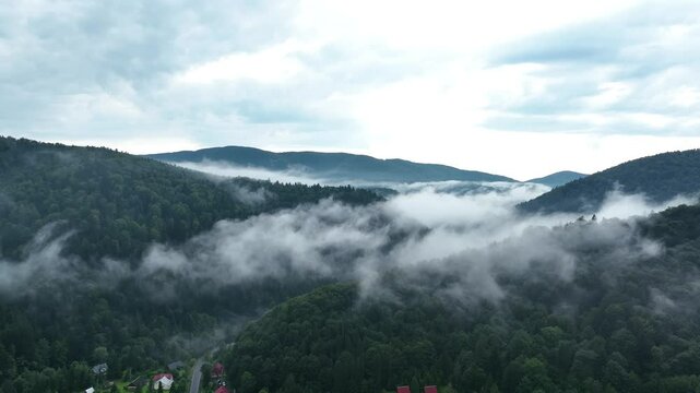 Drone flight over mountains in thick fog. Mavic 3