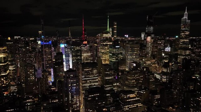 Aerial view of vibrant times square illuminated at night with bustling city lights and skyscrapers, New York City, United States.