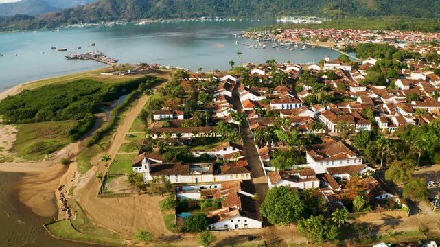 Aerial view of the beautiful historical center and coastline with lush greenery and mountains, Paraty, Brazil.