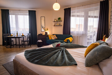 Luxurious modern bedroom. Hotel room style. Black and green decor. Kingsize bed with pillows. black closet.