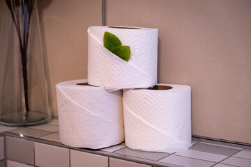 Stack of white toilet paper sitting on a shelf