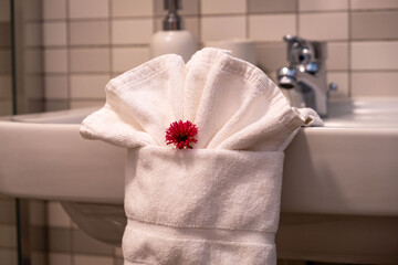 Folded white towers with a red flower