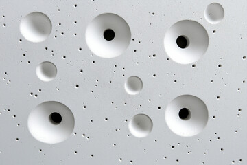 Close-up of white spherical bubbles on a textured surface for creative backgrounds