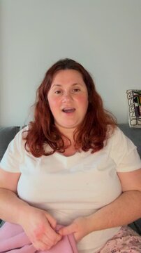 Real camera viewpoint of influencer showing clothes. Curvy woman live streaming on phone.