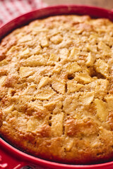 Autumn apple biscuit pie type charlotte in a red baking pan