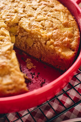 Autumn apple biscuit pie type charlotte in a red baking pan